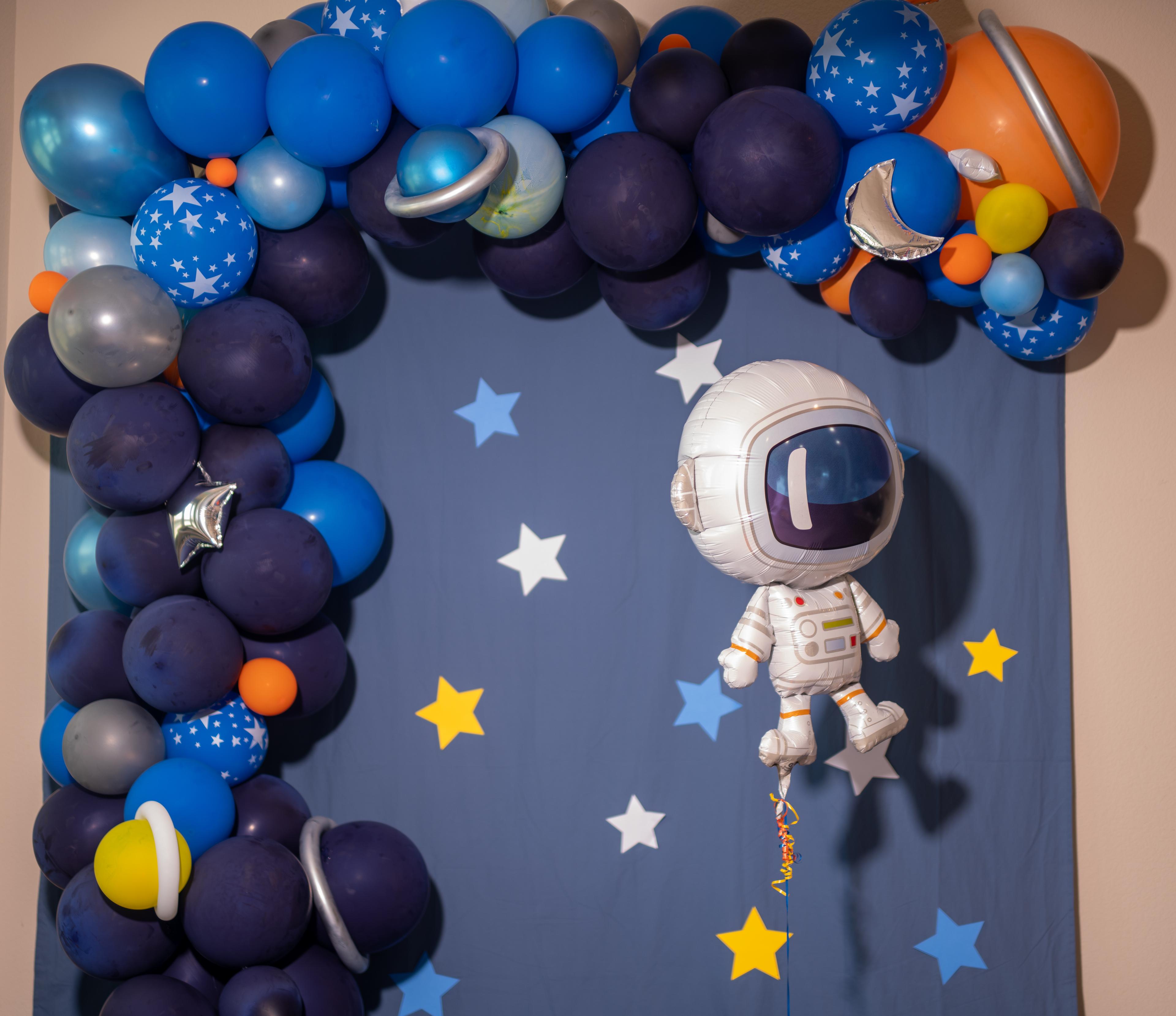 Astronaut in space with balloon arch