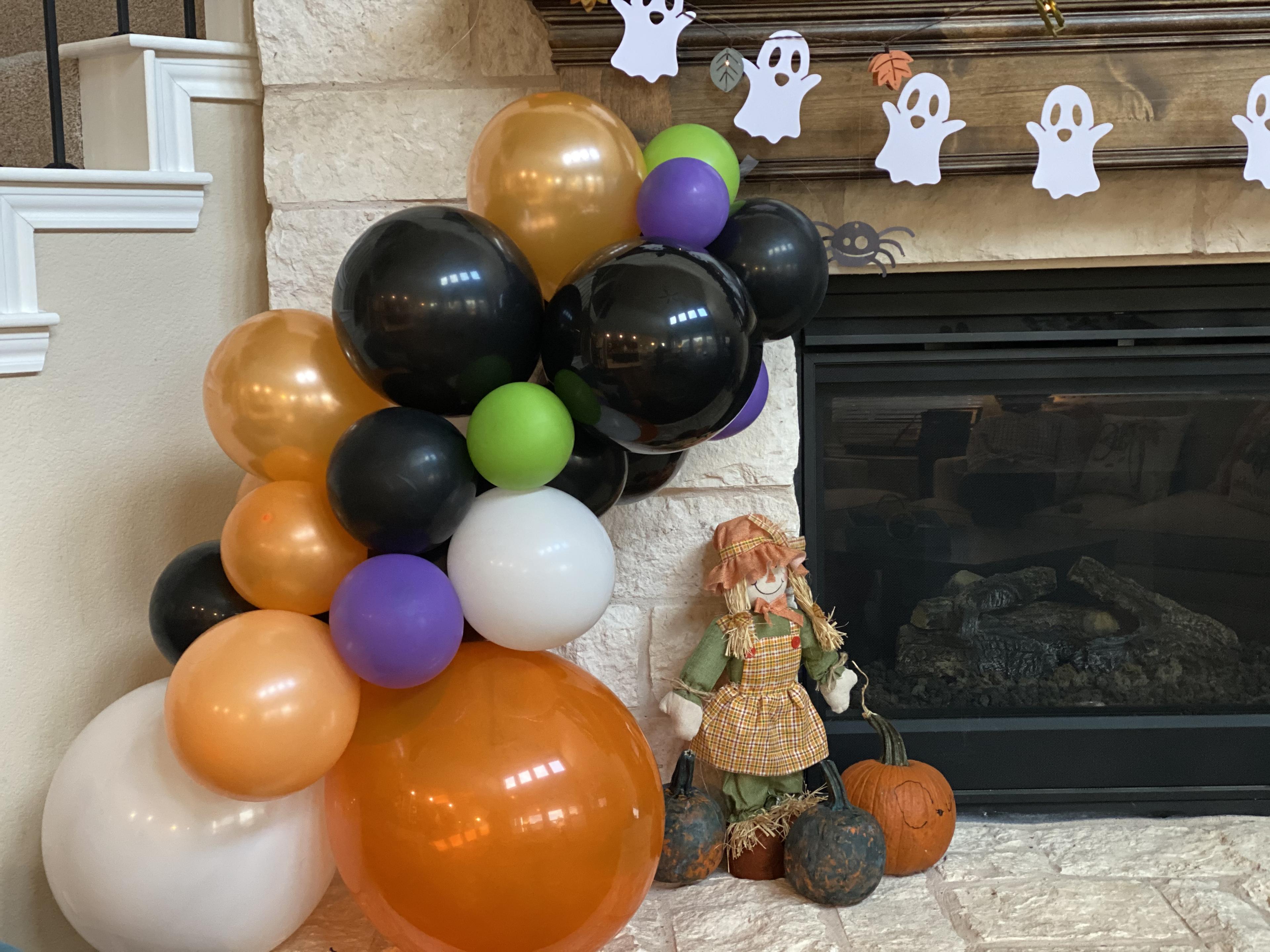 Autumn themed balloon arch with Halloween decor, multi-color